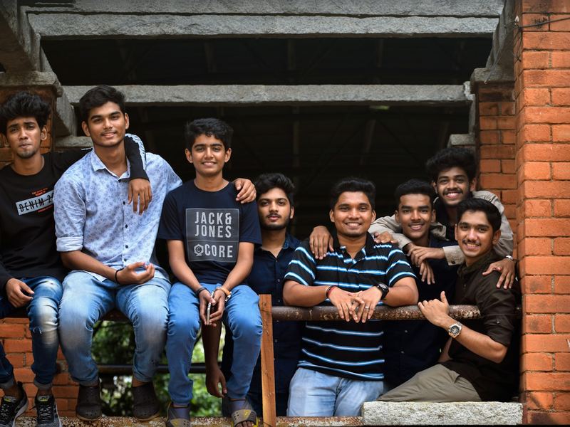 A cheerful group of young students posing together